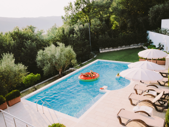 woman-relax-in-swimming-pool-at-sunset-outdoors